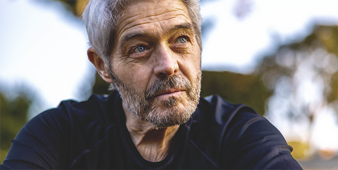 A middle-aged man with a questioning look thinks about questions about deep brain stimulation (DBS).